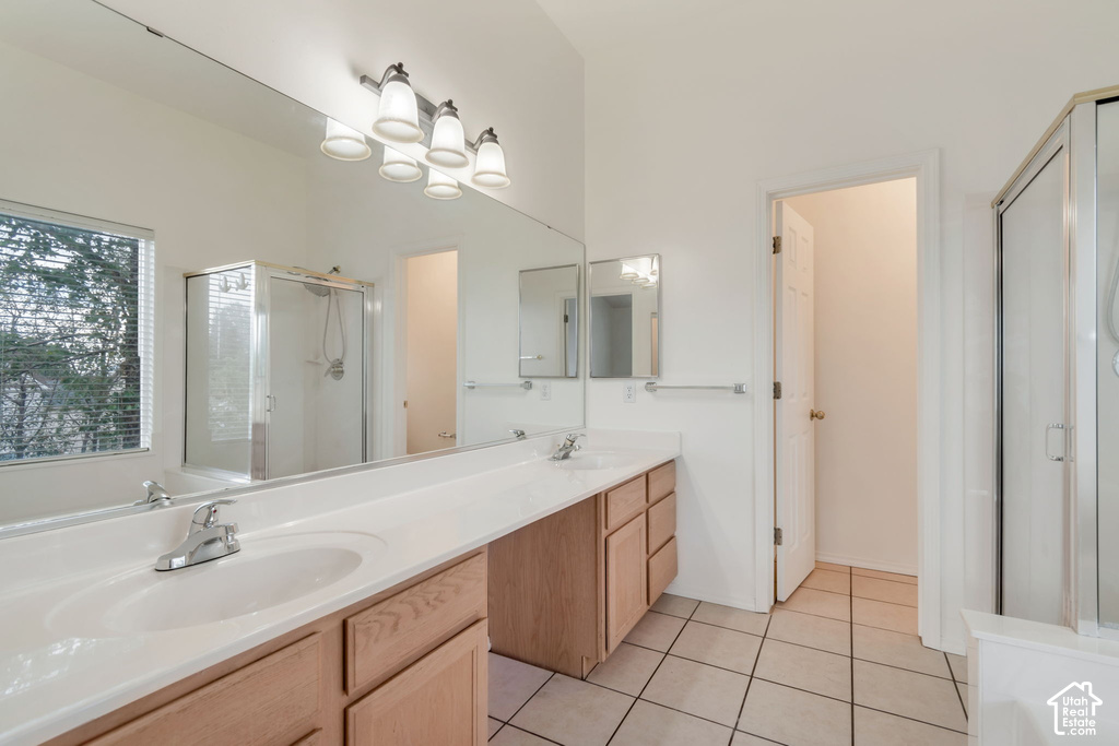 Dual vanity featuring integrated sinks, chrome fixtures, and wood cabinetry