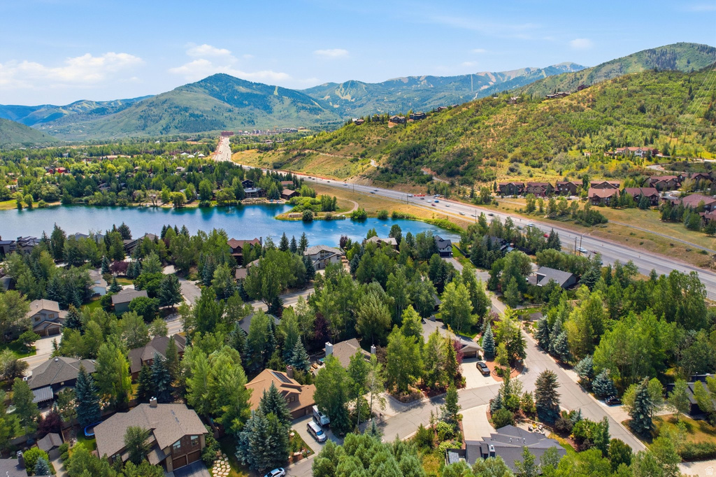 Aerial perspective of a developed residential area with a lake and surrounding mountainous landscape
