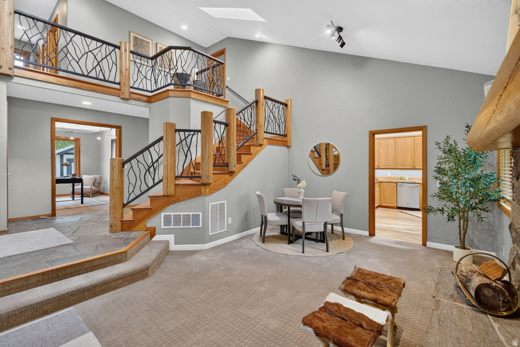 Multi-level interior featuring a grand staircase with custom wrought iron railings and wood newel posts