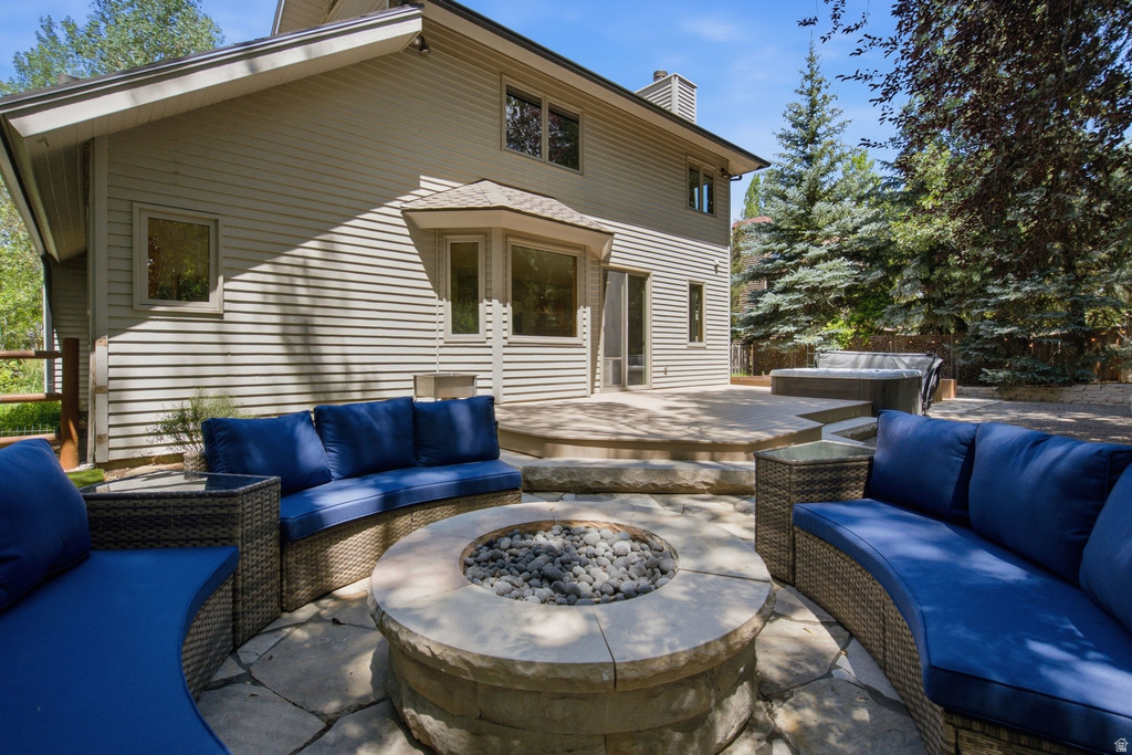 Expansive flagstone patio featuring a built-in fire pit
