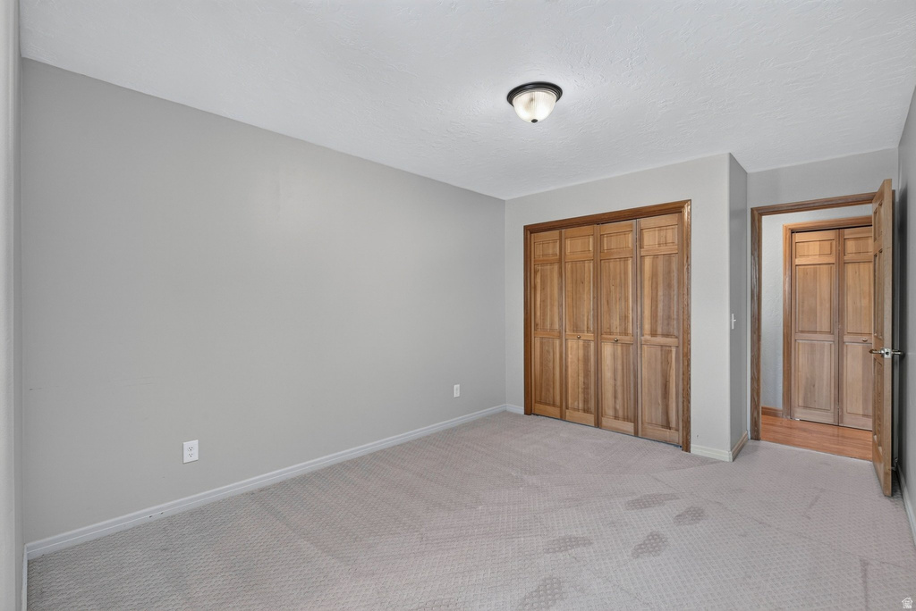 Neutral-toned wall paint and textured carpeting define this interior space