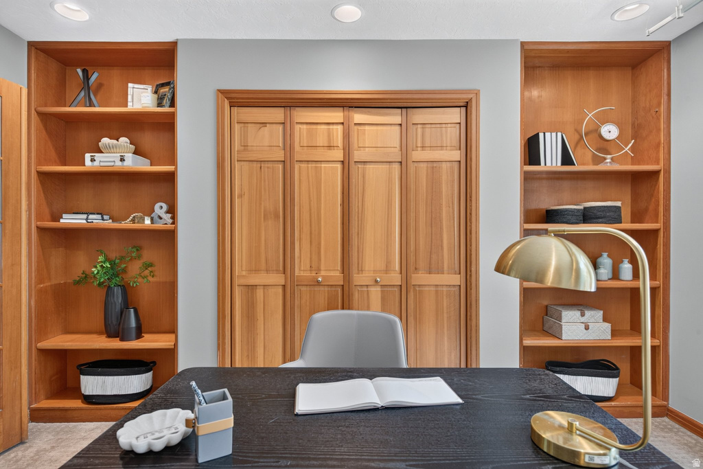 Integrated wood-finish shelving units flanking a wood-finish closet with bi-fold doors