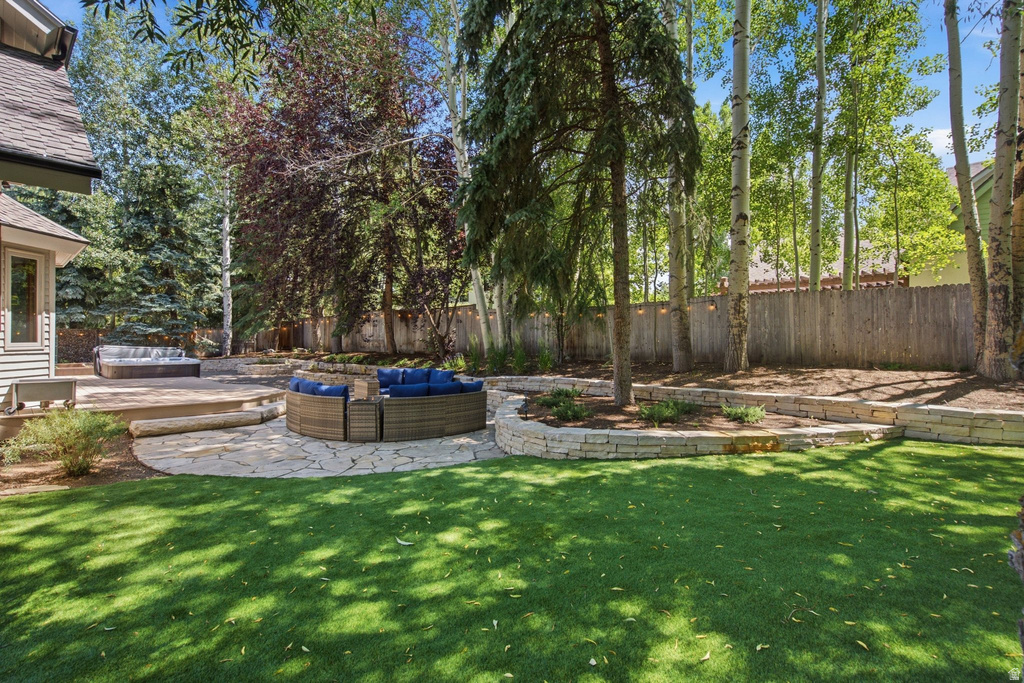 Expansive outdoor living area featuring a manicured lawn