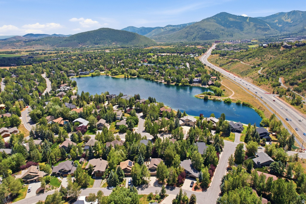 Aerial perspective showcasing a residential community with a central lake