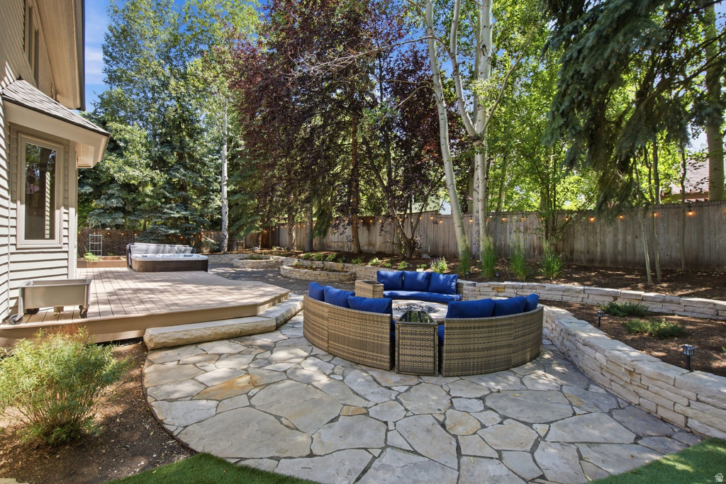 Expansive stone patio featuring a built-in fire pit