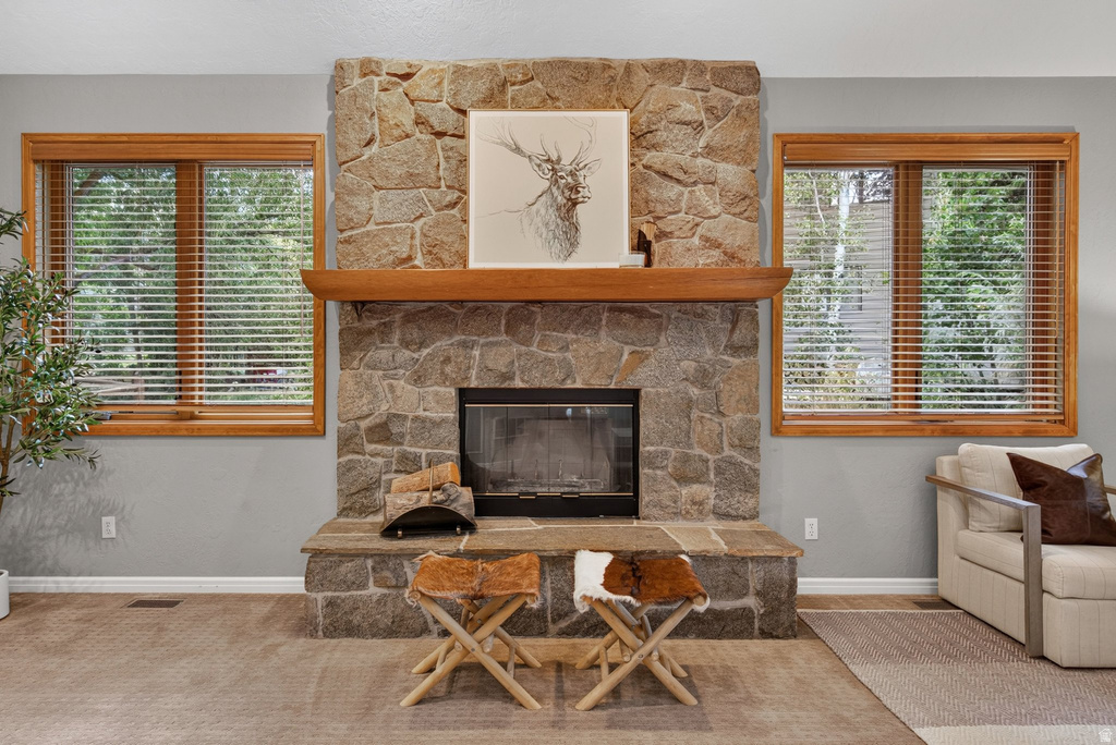 Stone-clad fireplace with a wood mantle and raised hearth