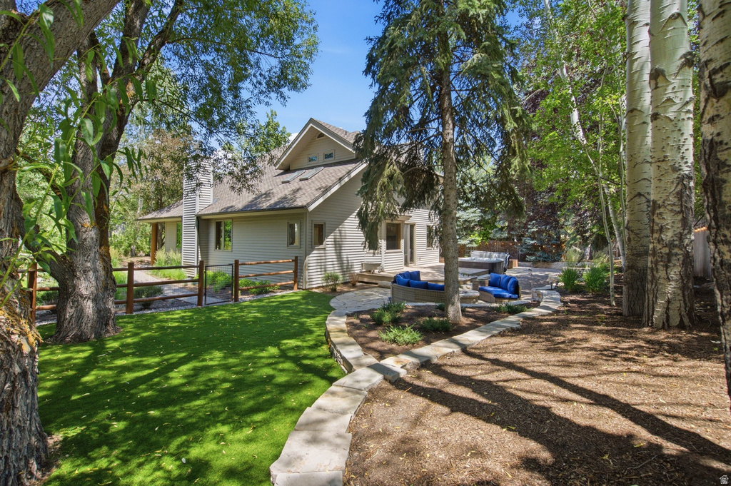 Backyard landscaping featuring a stone patio, built-in stone seating, and a perimeter stone retaining wall