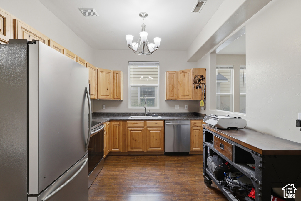 Kitchen featuring wood-finish flooring and light-toned cabinetry