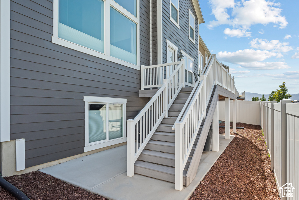 Multi-level deck with white railings and gray stairs