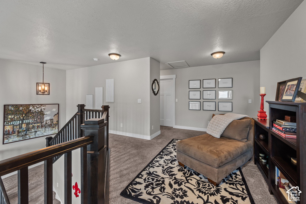 Carpeted landing featuring dark wood newel posts and railings