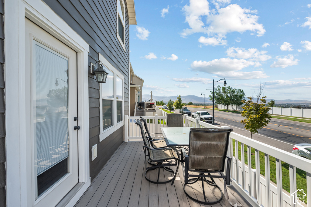 Outdoor deck featuring composite decking, white railing, and exterior siding