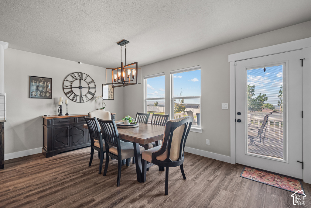 Dining area featuring wood-finish flooring, light gray walls, and multiple windows