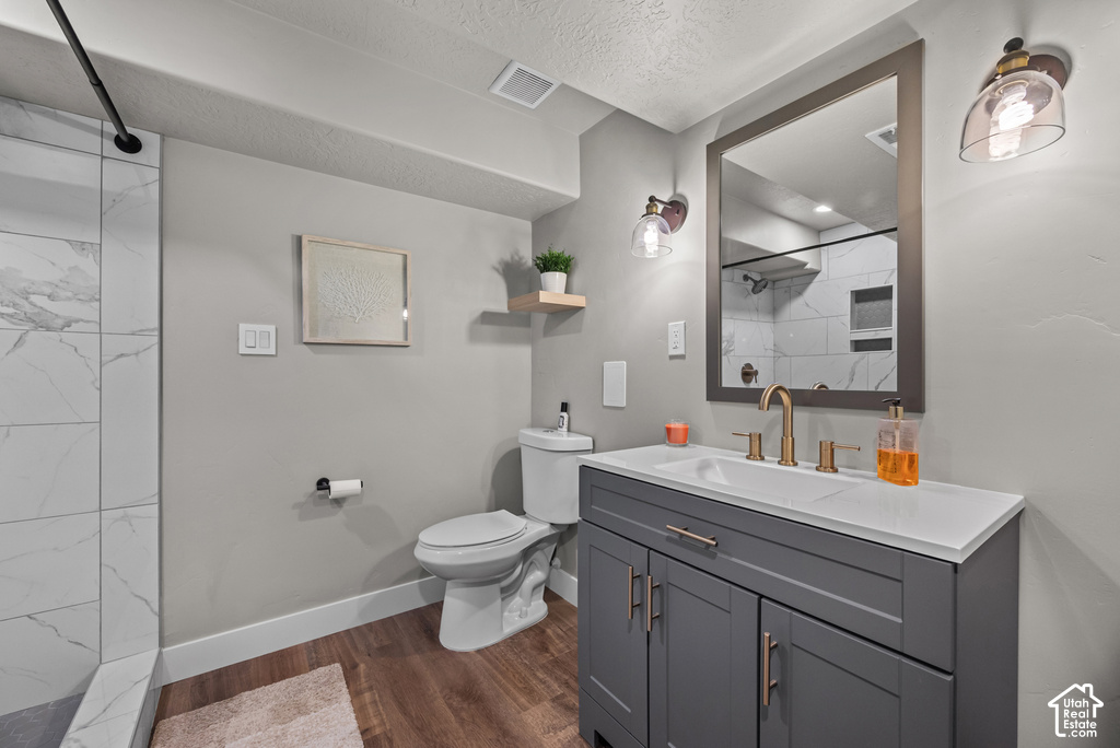 Contemporary bathroom featuring a grey vanity with a white countertop, gold-finish faucet, and coordinating hardware