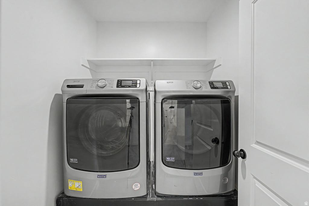 Dedicated laundry area featuring a front-load washer and dryer set