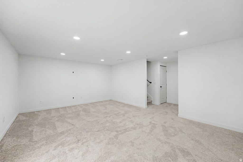 Spacious room featuring neutral carpeting and white walls