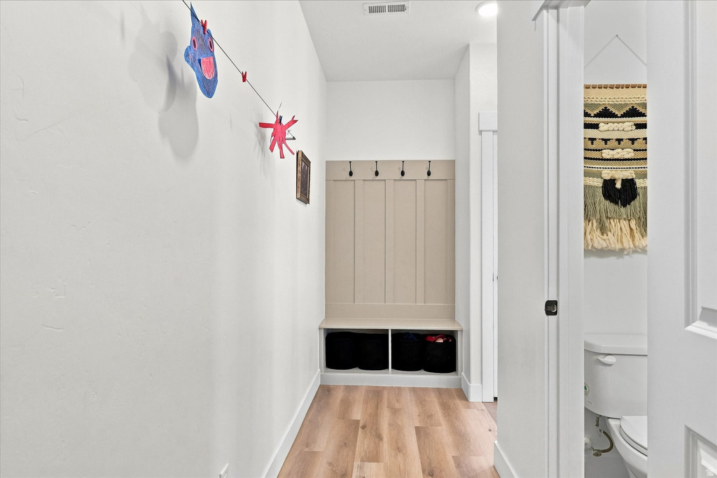 Built-in mudroom bench with paneled backing and integrated storage cubbies