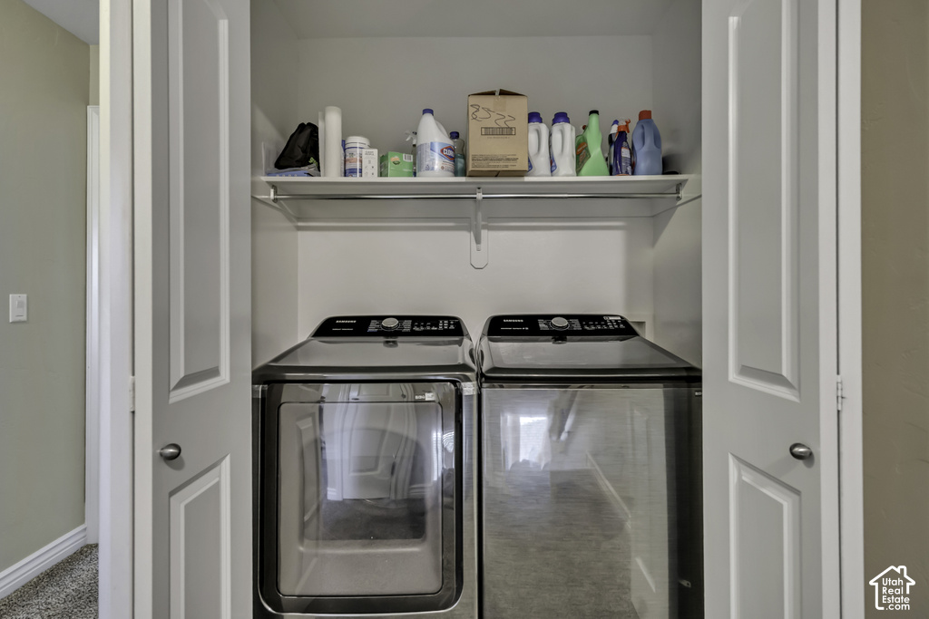 Dedicated laundry closet featuring a built-in shelf, hanging rod, and bi-fold doors