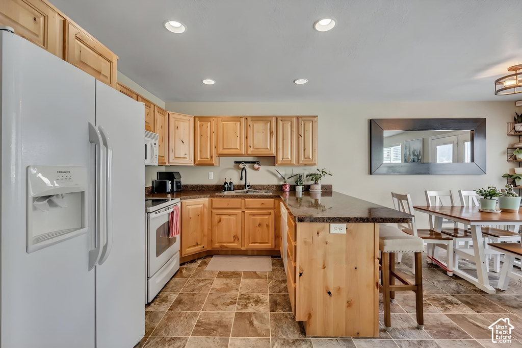 Kitchen featuring light wood cabinetry and a multi-toned tile floor