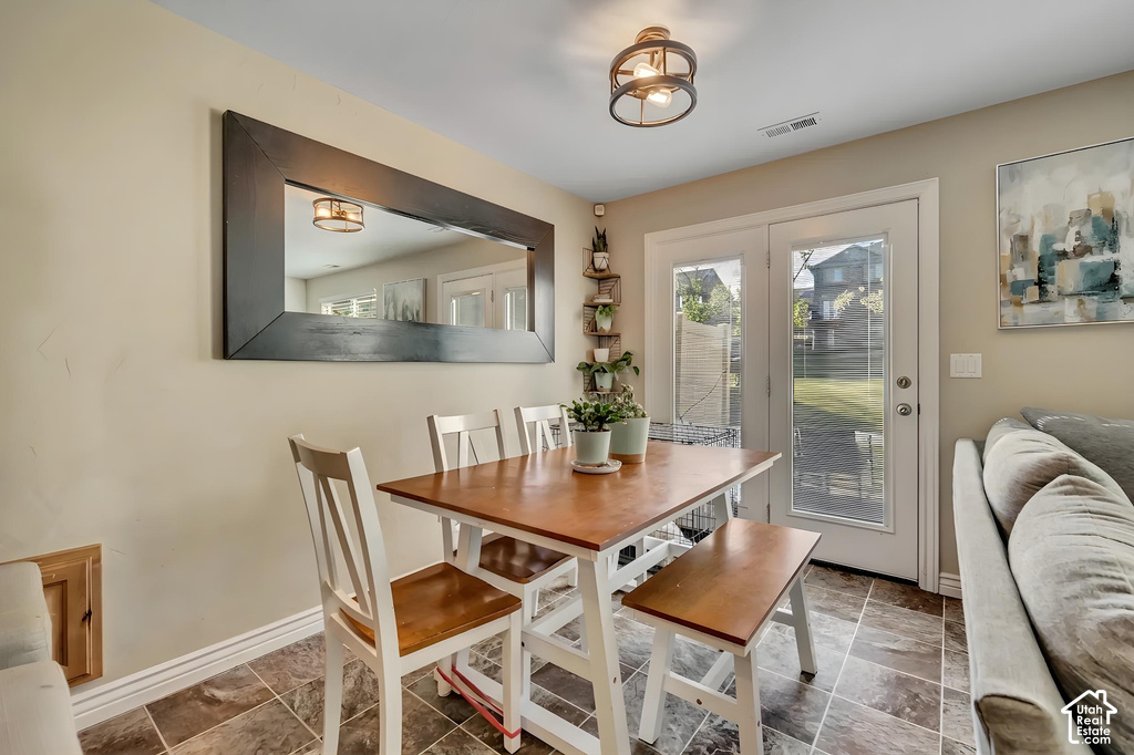 Dining area featuring patterned tile flooring and neutral wall tones