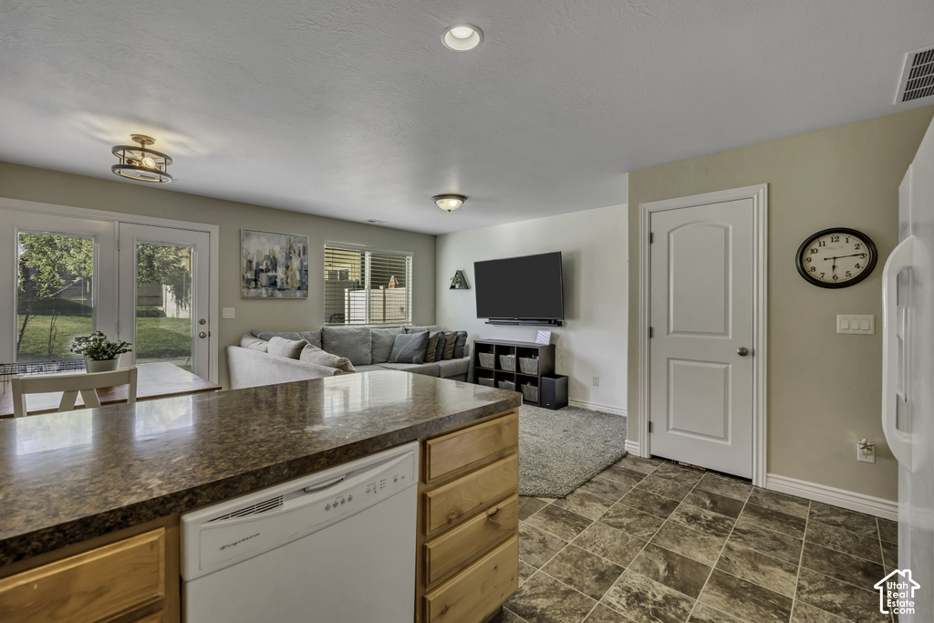 Kitchen island with integrated dishwasher and wood cabinetry