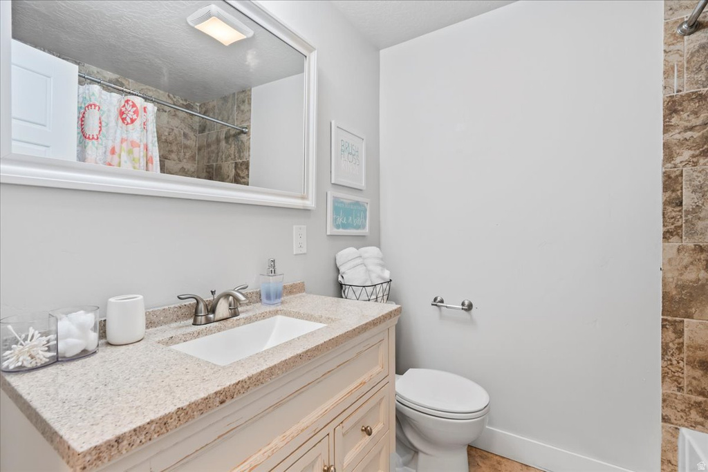 Bathroom vanity with an integrated rectangular sink and a speckled countertop