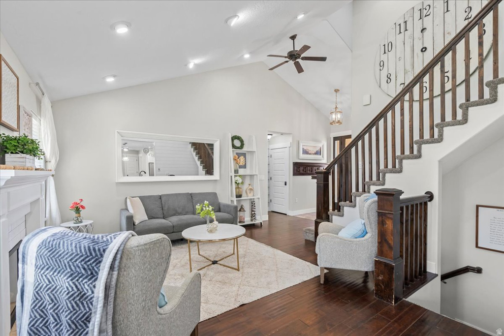 Vaulted ceilings featuring recessed lighting and a ceiling fan, complemented by dark wood-finish flooring