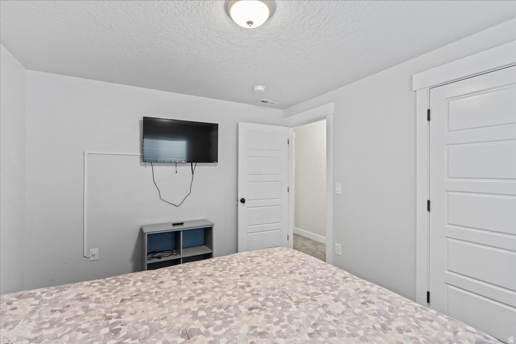 Bedroom featuring light gray walls, white baseboards, and white paneled doors