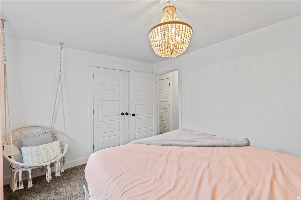 Bright room featuring a beaded chandelier and plank-style closet doors with black hardware