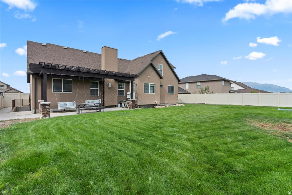Expansive rear lawn with perimeter fencing