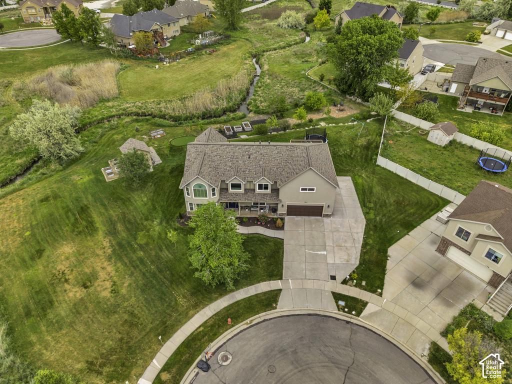 Two-story home with an attached garage, featuring a large driveway and a cul-de-sac location