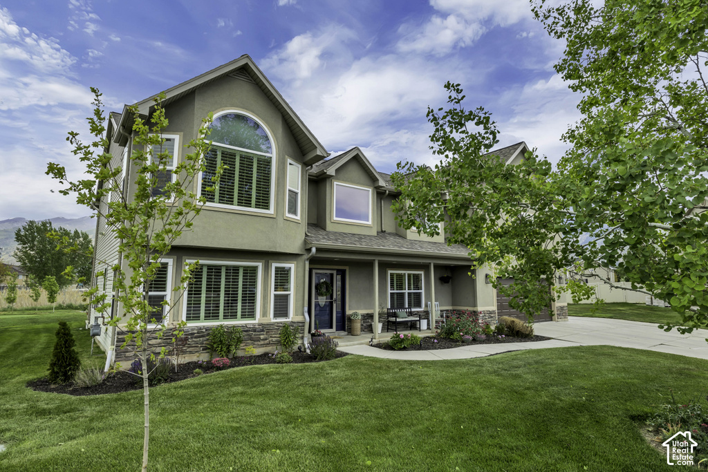 Two-story exterior featuring stucco siding and stone accents