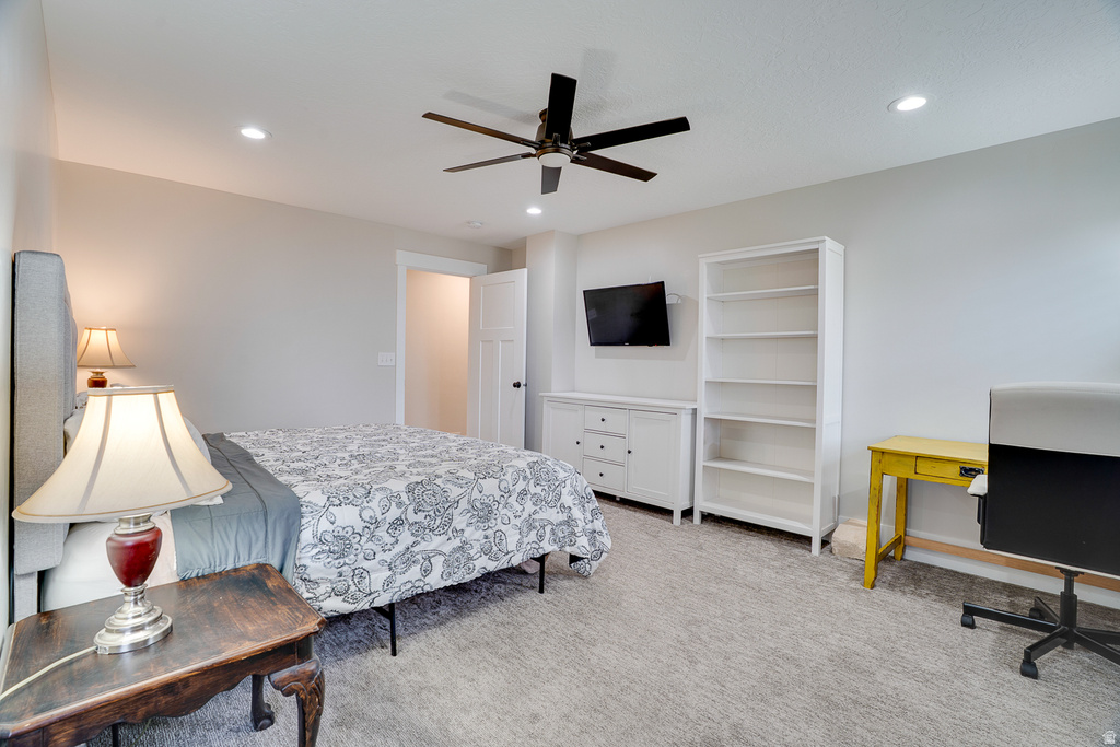 Carpeted bedroom featuring recessed lighting and a ceiling fan