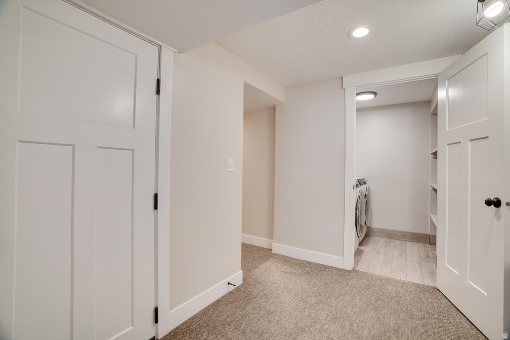 Dedicated laundry area with tile-finish flooring and integrated shelving