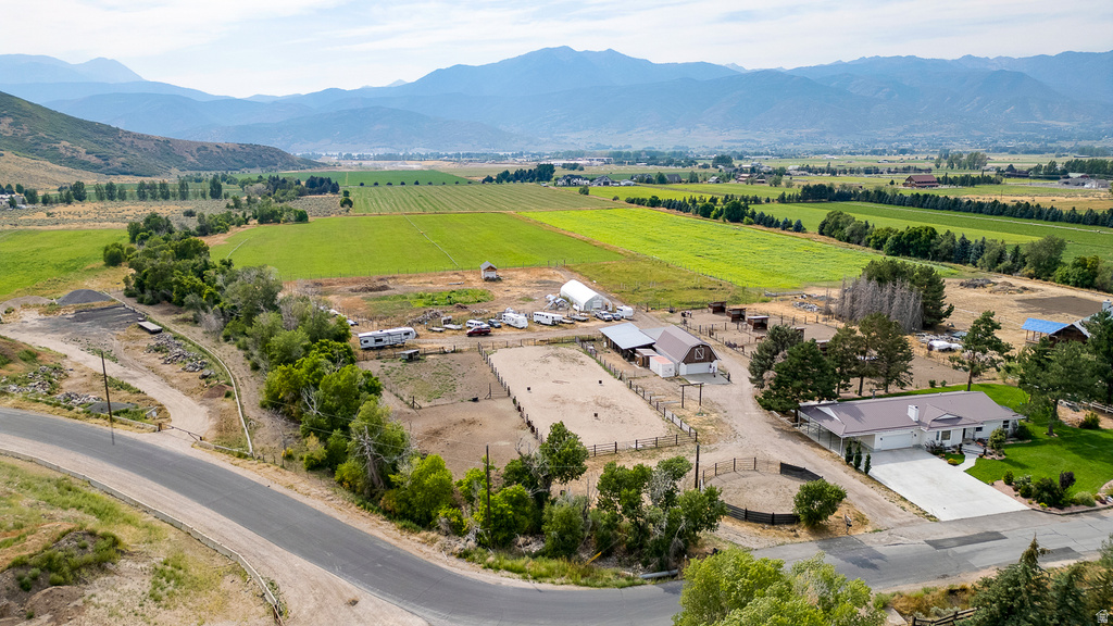 Expansive property featuring a single-story residence, multiple outbuildings, and agricultural fields