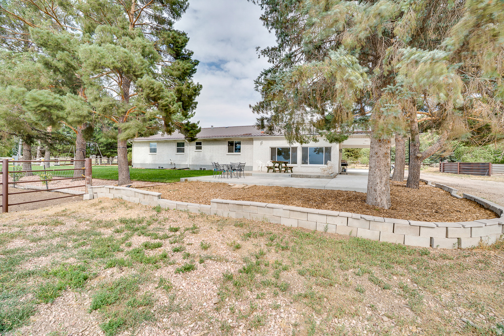 Charming single-story residence situated on expansive grounds featuring mature trees and open lawn space