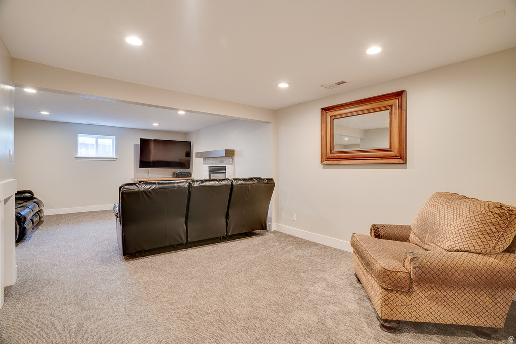 Lower-level recreation space featuring neutral wall paint and light-colored carpeting