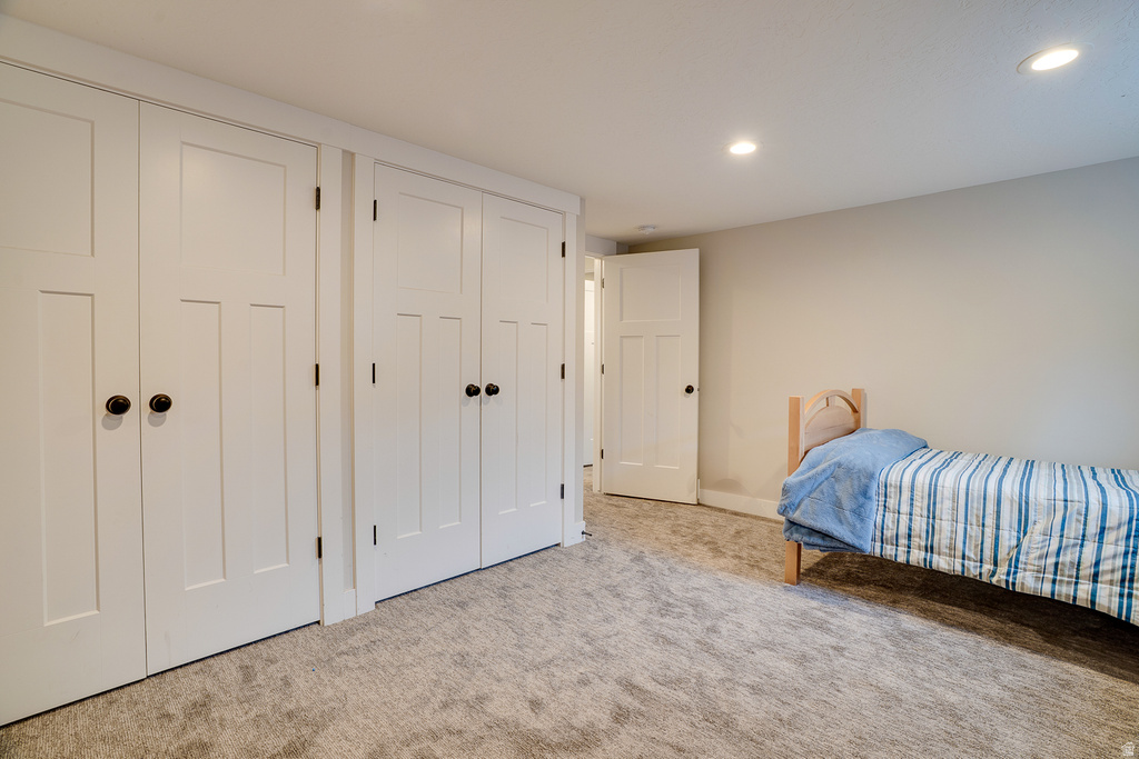 Room featuring extensive built-in storage with white shaker-style doors and dark hardware