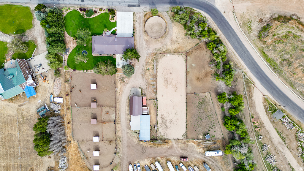 Expansive property featuring a main residence with a manicured lawn, multiple outbuildings, and an equestrian arena