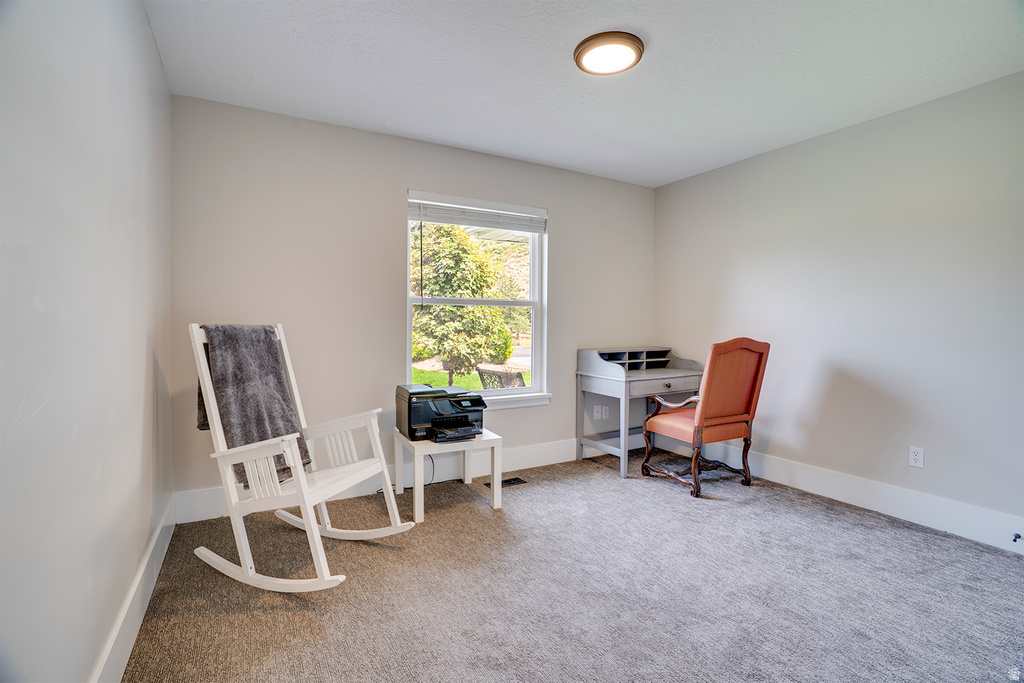 Carpeted room featuring a single window, recessed lighting, and white baseboards