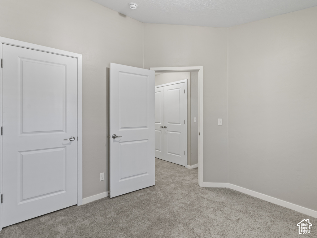 Room featuring light gray carpet flooring and neutral painted walls