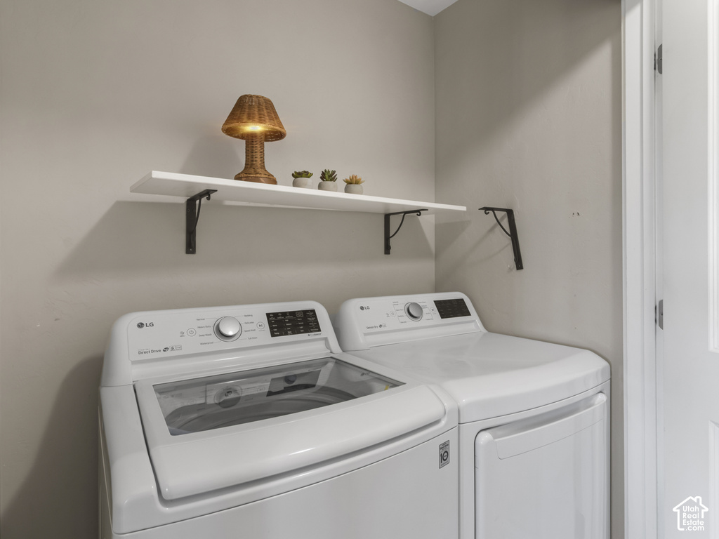 Laundry area featuring a floating white shelf with dark metal brackets