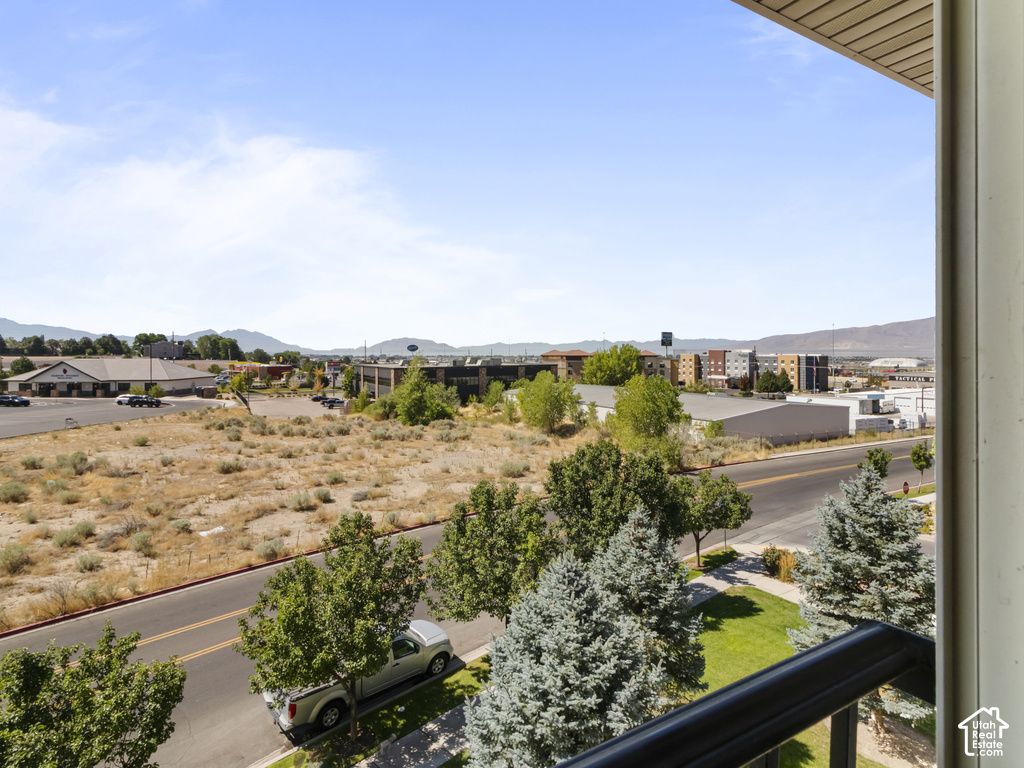 Elevated vantage point showcasing mature landscaping with established trees, manicured grounds, and thoughtful hardscaping along the property perimeter