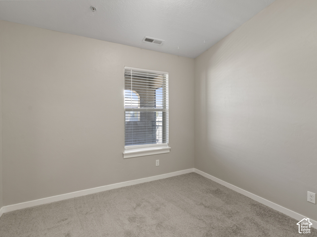 Neutral-toned carpeting complements the light-colored walls and white trim