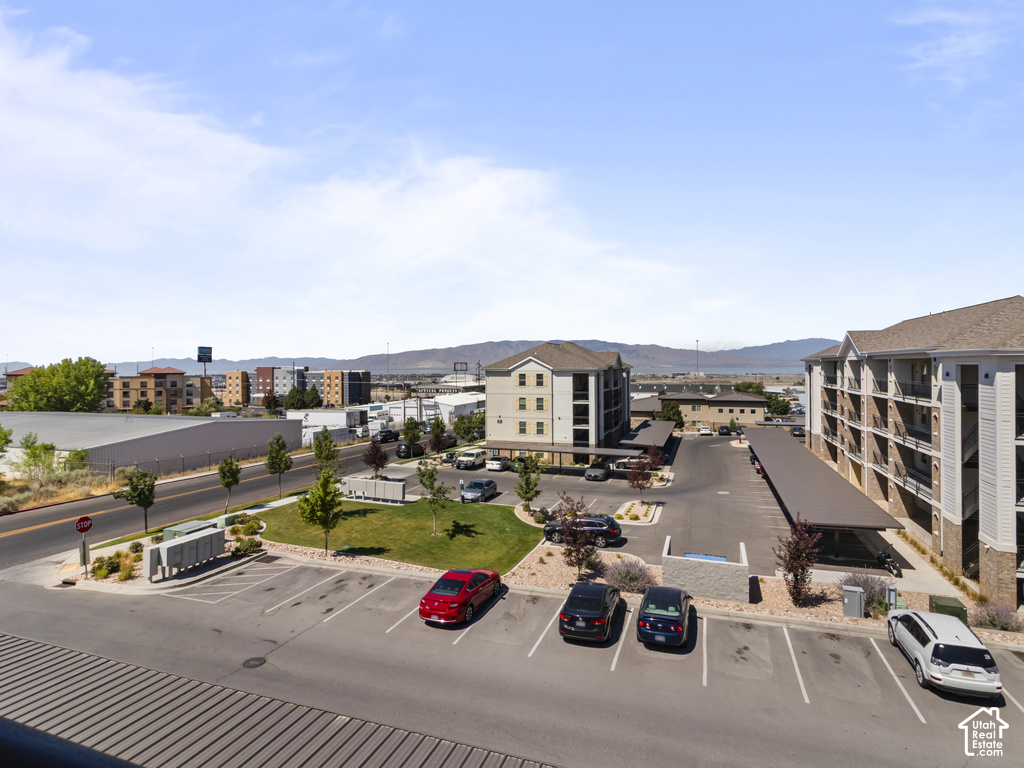 Expansive parking area featuring multiple covered spaces and landscaping elements