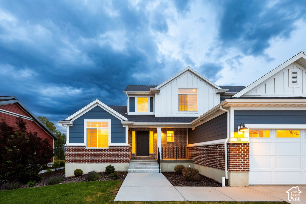 Modern two-story residence featuring a striking mixed-material exterior combining crisp white siding with brick detailing