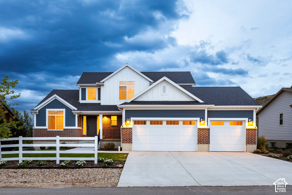 Modern two-story residence featuring blue siding, white trim, and brick accents