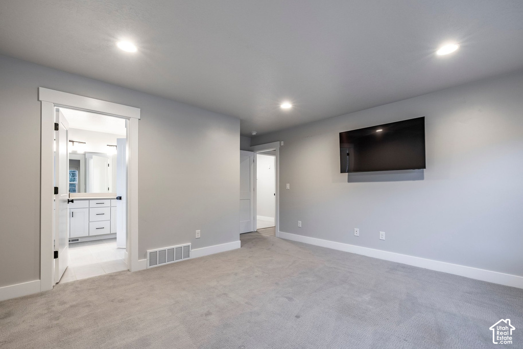Spacious room featuring plush gray carpeting and recessed lighting