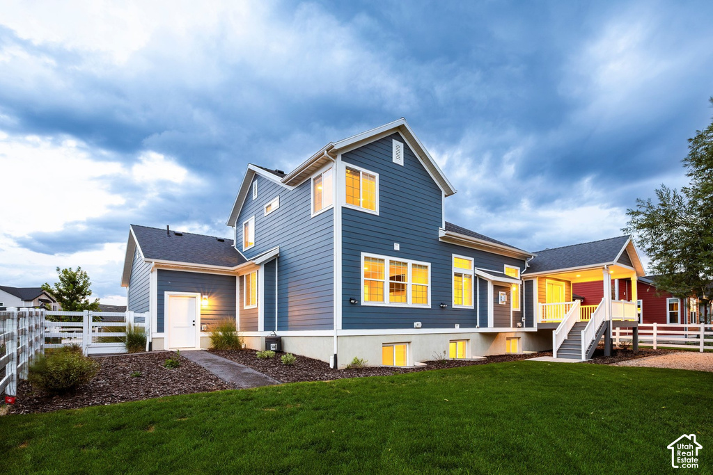Contemporary multi-level exterior with blue siding, white trim, and a covered porch featuring white railings and stairs