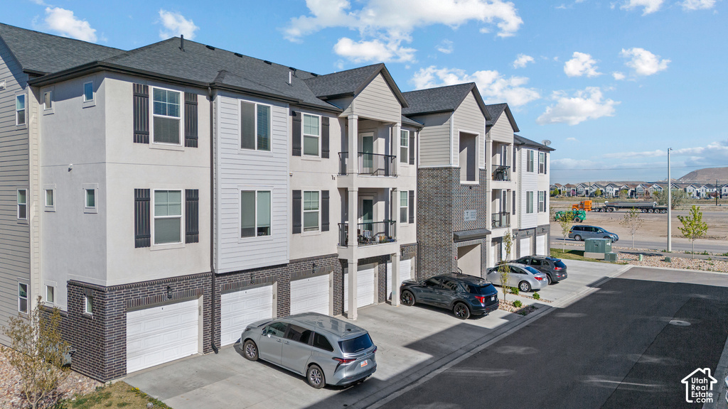 Modern townhome community featuring clean-lined architecture with mixed exterior finishes including fiber cement siding and stone accents