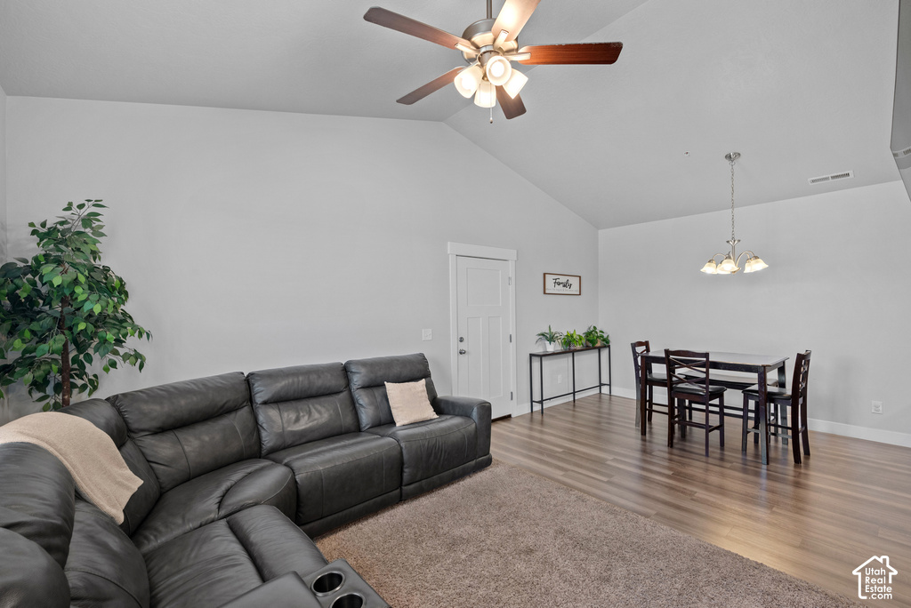 Vaulted ceilings and wood-finish flooring define this open living space